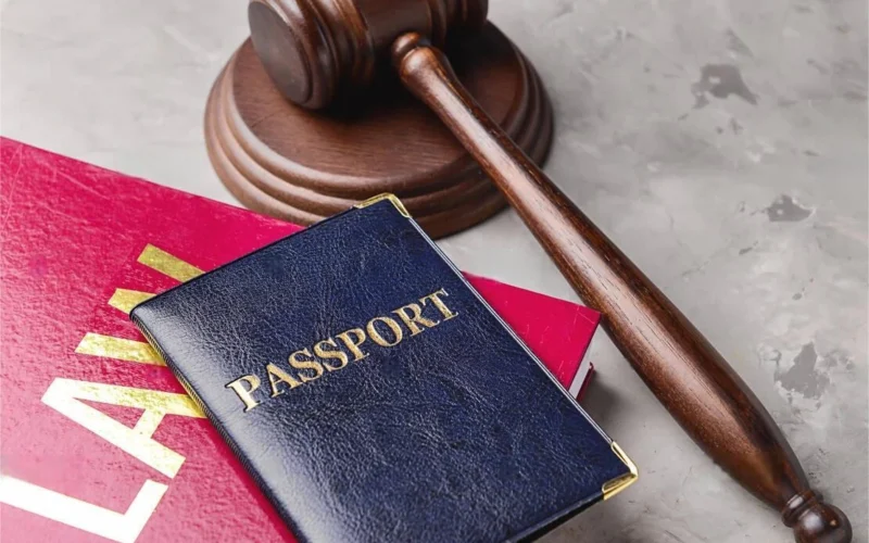 judges-gavel-book-and-passport-on-table-immigration-law-concept